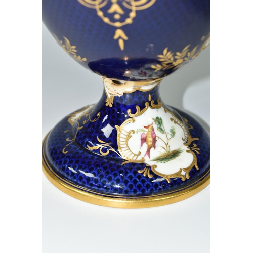 367 - A COALPORT COVERED PEDESTAL VASE, with pierced twin handles, a cobalt blue patterned ground with rai... 