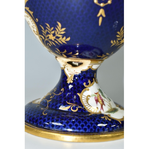 367 - A COALPORT COVERED PEDESTAL VASE, with pierced twin handles, a cobalt blue patterned ground with rai... 