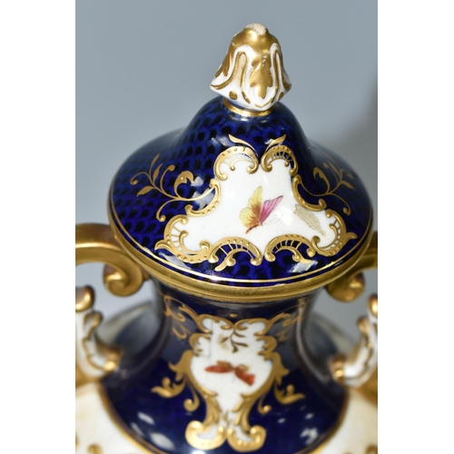 367 - A COALPORT COVERED PEDESTAL VASE, with pierced twin handles, a cobalt blue patterned ground with rai... 