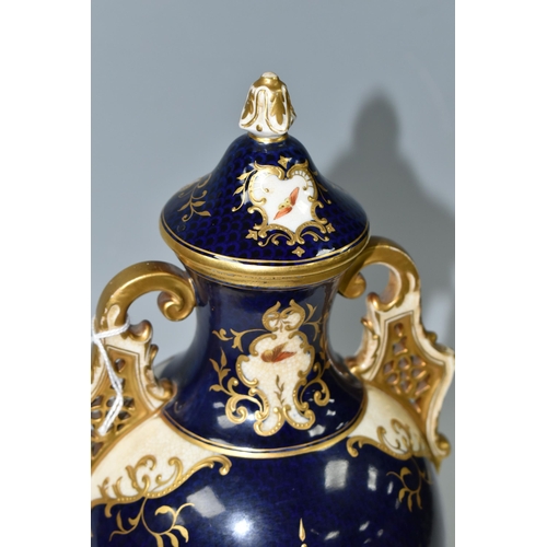 367 - A COALPORT COVERED PEDESTAL VASE, with pierced twin handles, a cobalt blue patterned ground with rai... 