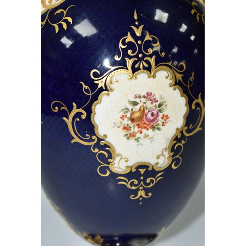 367 - A COALPORT COVERED PEDESTAL VASE, with pierced twin handles, a cobalt blue patterned ground with rai... 