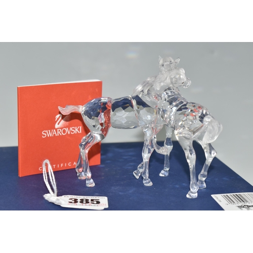 385 - A BOXED SWAROVSKI CRYSTAL 'FOALS - CLEAR' SCULPTURE, depicting two foals playing, model no 627637, f... 