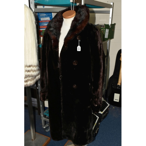 435 - A VINTAGE LADIES DARK BROWN  COAT, with a brown fur collar, covered buttons, embroidered satin linin... 