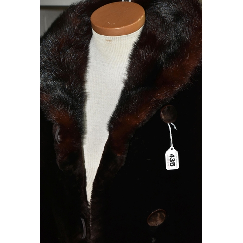 435 - A VINTAGE LADIES DARK BROWN  COAT, with a brown fur collar, covered buttons, embroidered satin linin... 