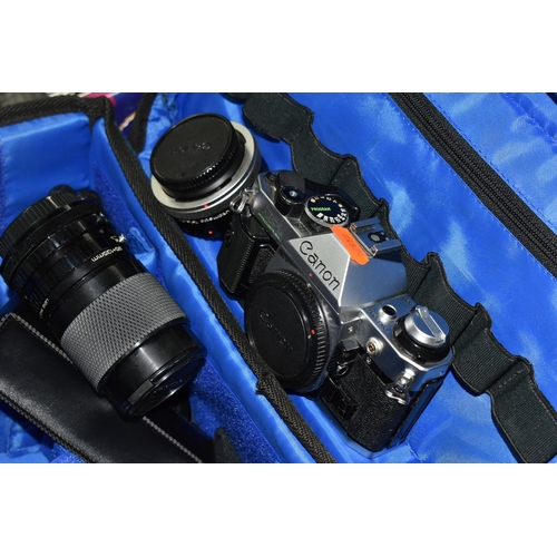 453 - A CAMERA BAG CONTAINING A CANON CAMERA AND SELECTION OF LENSES, comprising a Canon AE-1 program came... 