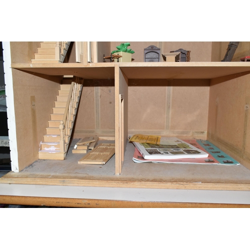 522 - A MODERN WOODEN DOLLS HOUSE, modelled as a two storey villa, front opens to reveal two rooms over tw... 