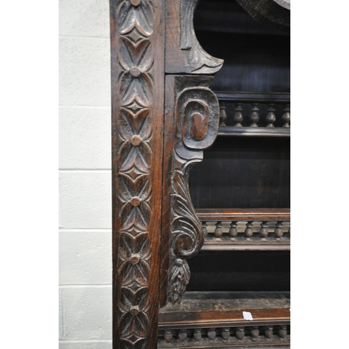 1201 - A TALL HARDWOOD WALL CABINET, with a variety of intricate carved designs, consisting of spindles, wh... 