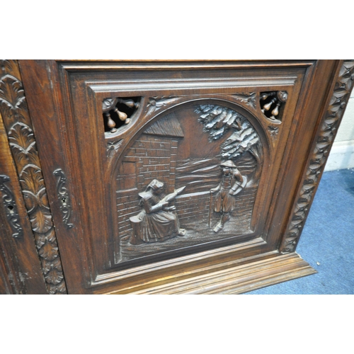 1202 - A CARVED OAK BRETON SIDEBOARD, fitted with an arrangement of five panel doors, depicting humans in v... 