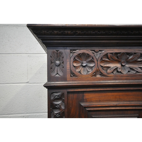 1202 - A CARVED OAK BRETON SIDEBOARD, fitted with an arrangement of five panel doors, depicting humans in v... 