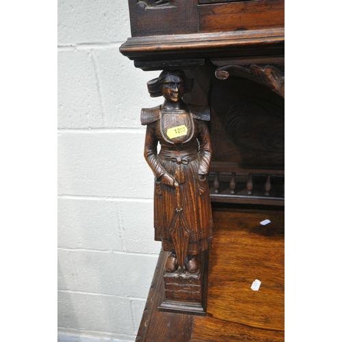 1202 - A CARVED OAK BRETON SIDEBOARD, fitted with an arrangement of five panel doors, depicting humans in v... 