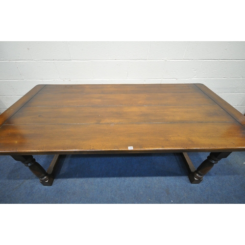 1204 - A GOOD QUALITY REPRODUCTION SOLID OAK REFECTORY TABLE, on block and turned legs, united by a H stret... 