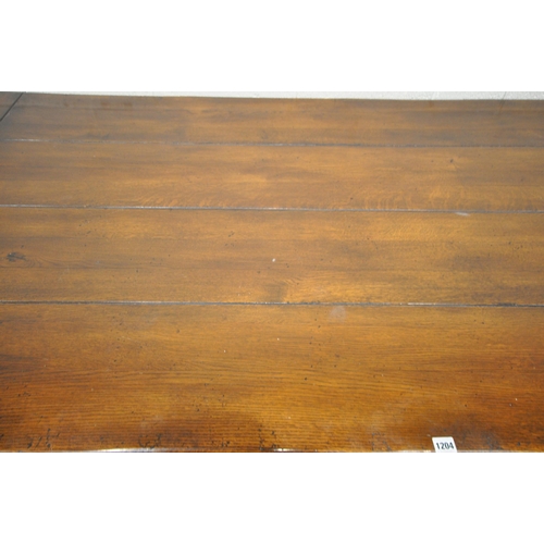 1204 - A GOOD QUALITY REPRODUCTION SOLID OAK REFECTORY TABLE, on block and turned legs, united by a H stret... 