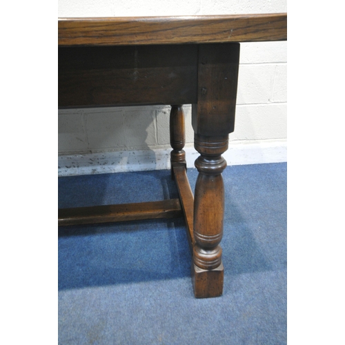 1204 - A GOOD QUALITY REPRODUCTION SOLID OAK REFECTORY TABLE, on block and turned legs, united by a H stret... 