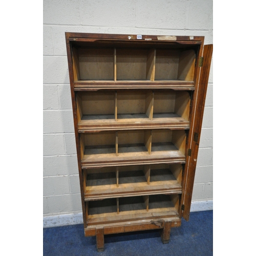 1215 - A GOVERNMENT ISSUE STAVERTON OAK BOOKCASE, with five rise and fall doors, enclosing an arrangement o... 