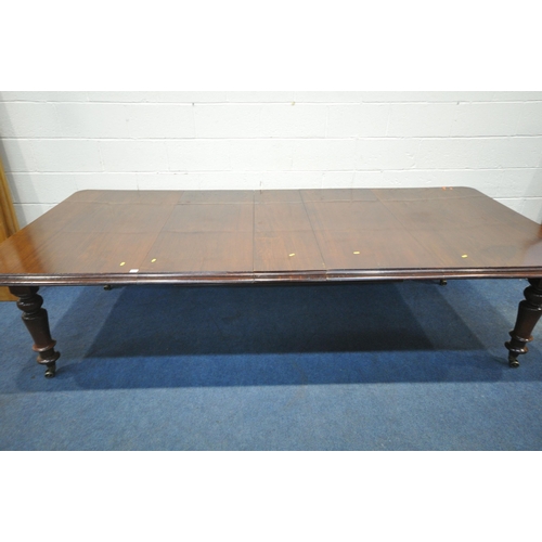 1217 - A VICTORIAN MAHOGANY EXTENDING PULL-OUT DINING TABLE, with three additional leaves, on turned legs a... 