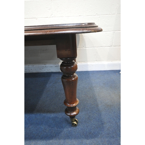 1217 - A VICTORIAN MAHOGANY EXTENDING PULL-OUT DINING TABLE, with three additional leaves, on turned legs a... 