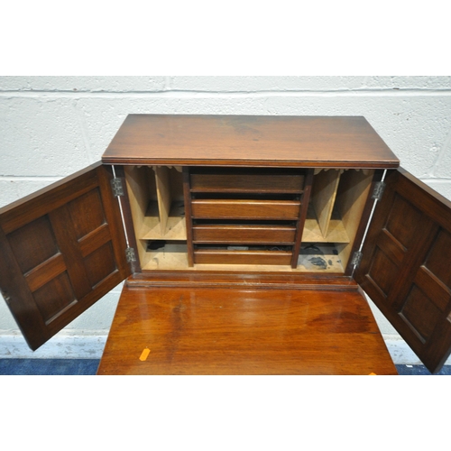 1220 - AN EARLY 20TH CENTURY MAHOGANY DAVENPORT, fitted with a double door top section, enclosing four draw... 