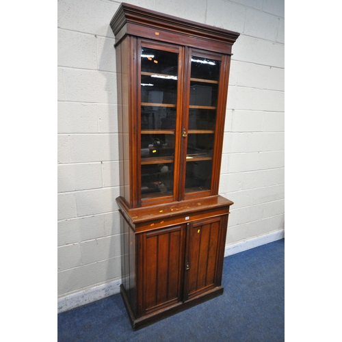 1227 - A 20TH CENTURY MAHOGANY BOOKCASE, fitted with double glazed doors and double cupboard doors, enclosi... 