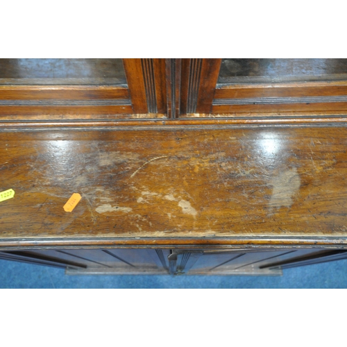 1227 - A 20TH CENTURY MAHOGANY BOOKCASE, fitted with double glazed doors and double cupboard doors, enclosi... 