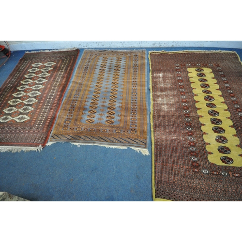 1256 - THREE PATTERNED WOOL RUGS, the largest rug with a repeating border, central medallions with a tan bo... 