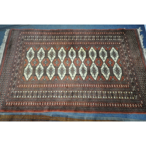 1256 - THREE PATTERNED WOOL RUGS, the largest rug with a repeating border, central medallions with a tan bo... 