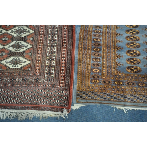 1256 - THREE PATTERNED WOOL RUGS, the largest rug with a repeating border, central medallions with a tan bo... 