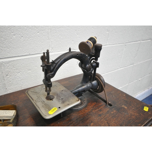 1258 - A VINTAGE WILLCOX AND GIBBS TREADLE SEWING MACHINE, serial number A481848 which appears to come with... 