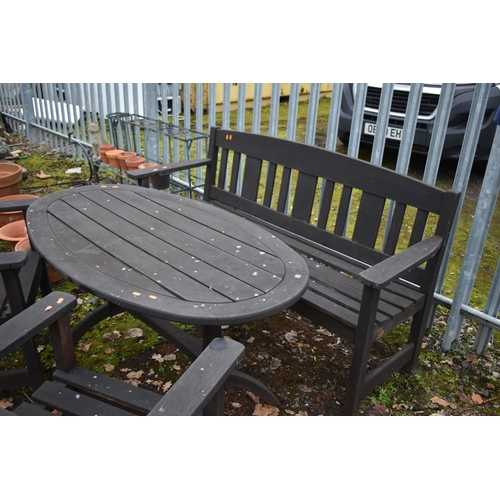 1002 - A WEATHERED STAINED TEAK PATIO SET, to include an oval table on trestle legs, length and height 140c... 