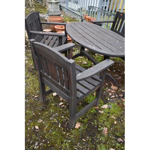 1002 - A WEATHERED STAINED TEAK PATIO SET, to include an oval table on trestle legs, length and height 140c... 