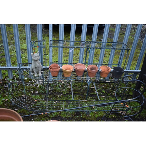 1004 - A WROUGHT IRON THREE TIER PLANTING STAND, comprising a rectangular and a corner section, a hanging b... 