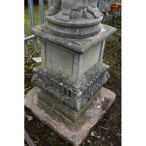 1005 - A LARGE WEATHERED COMPOSITE SUN DIAL, depicting three nude putto's holding the top aloft, on a squar... 