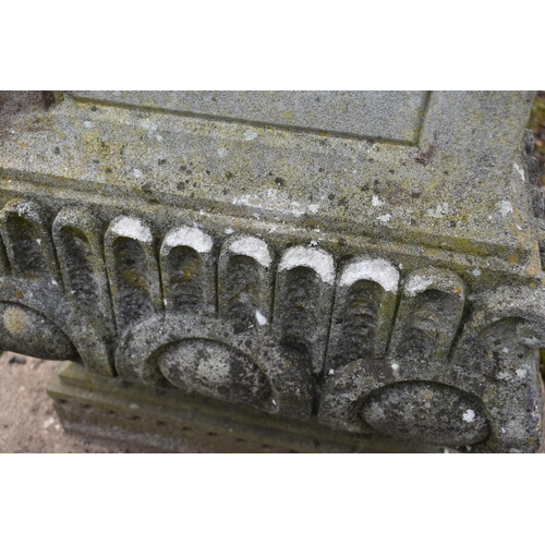 1005 - A LARGE WEATHERED COMPOSITE SUN DIAL, depicting three nude putto's holding the top aloft, on a squar... 