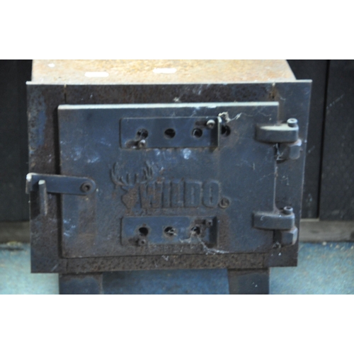 1111 - A 'WILDO' SOLID FUEL WORKSHOP STOVE with 155cm flue, fire box width 30cm depth 45cm height on legs 4... 