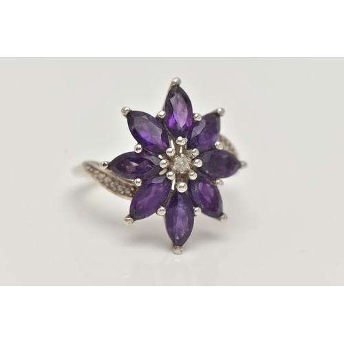 10 - AN AMETHYST FLOWER RING, designed as amethyst petals to the cross over design shoulders, stamped 925... 