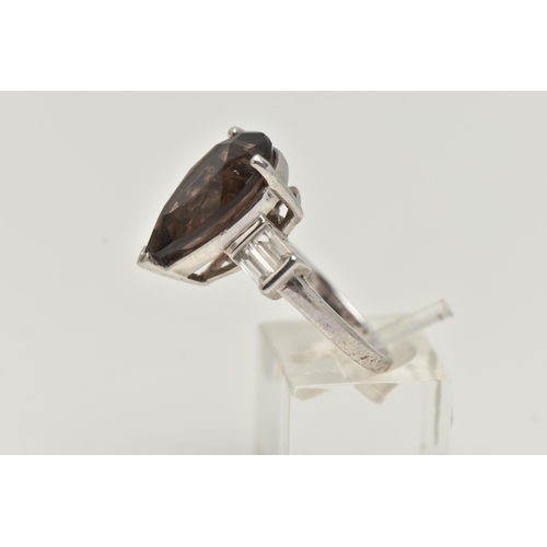 11 - A GEM SET RING, designed as a central pear shape smokey quartz flanked by rectangular shape white to... 