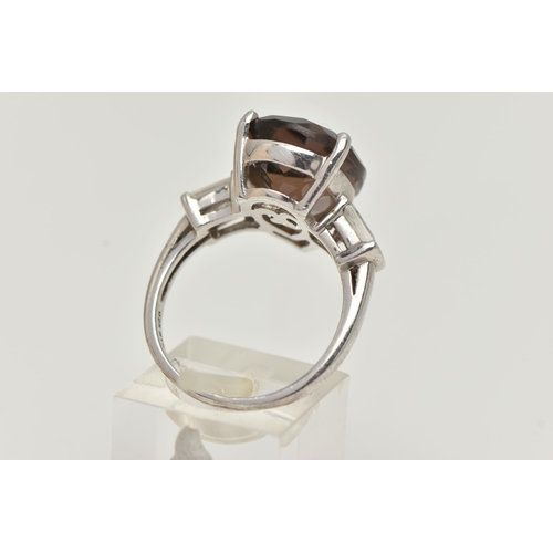 11 - A GEM SET RING, designed as a central pear shape smokey quartz flanked by rectangular shape white to... 