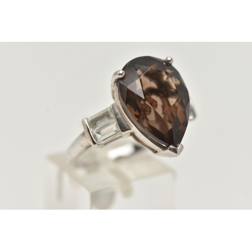 11 - A GEM SET RING, designed as a central pear shape smokey quartz flanked by rectangular shape white to... 