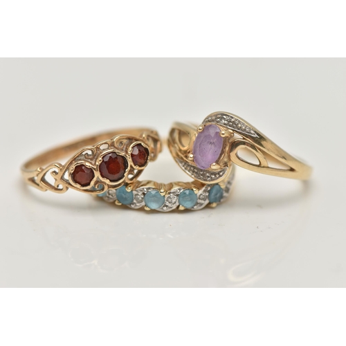 2 - THREE 9CT GOLD GEM SET RINGS, the first of cross over design set with a central oval cut amethyst wi... 