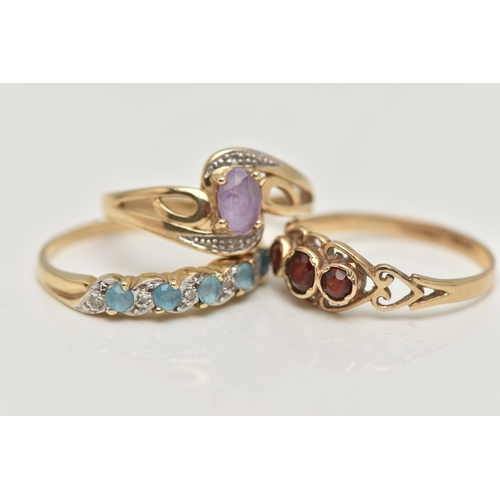 2 - THREE 9CT GOLD GEM SET RINGS, the first of cross over design set with a central oval cut amethyst wi... 