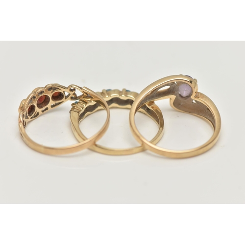 2 - THREE 9CT GOLD GEM SET RINGS, the first of cross over design set with a central oval cut amethyst wi... 