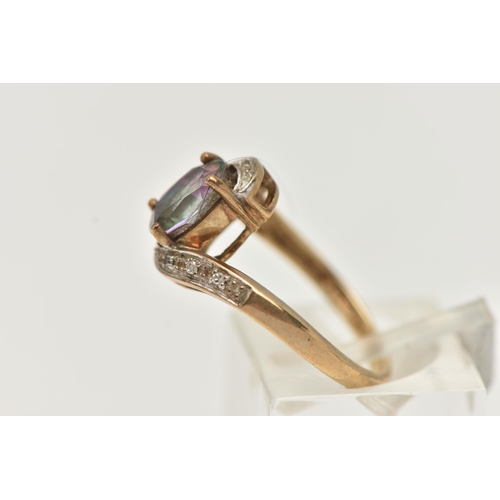 20 - A 9CT GOLD MYSTIC TOPAZ AND DIAMOND RING, centring on an oval cut mystic topaz, four claw set, withi... 