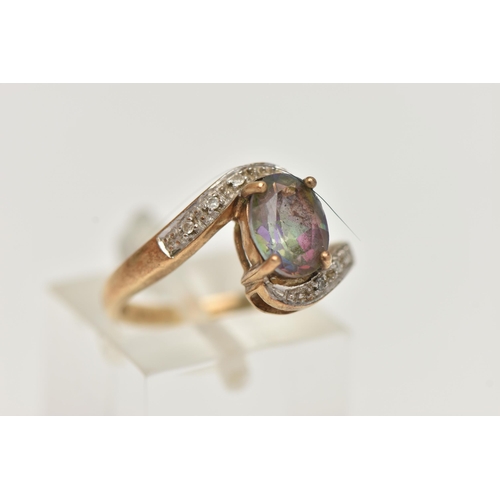 20 - A 9CT GOLD MYSTIC TOPAZ AND DIAMOND RING, centring on an oval cut mystic topaz, four claw set, withi... 