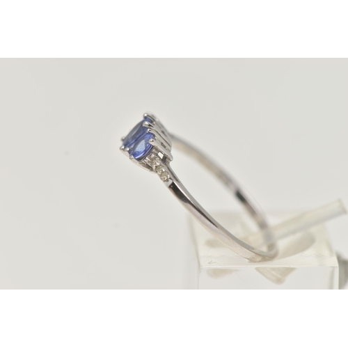 25 - A 14CT WHITE GOLD TANZANITE AND DIAMOND RING, three oval cut tanzanite, each four claw set, small si... 