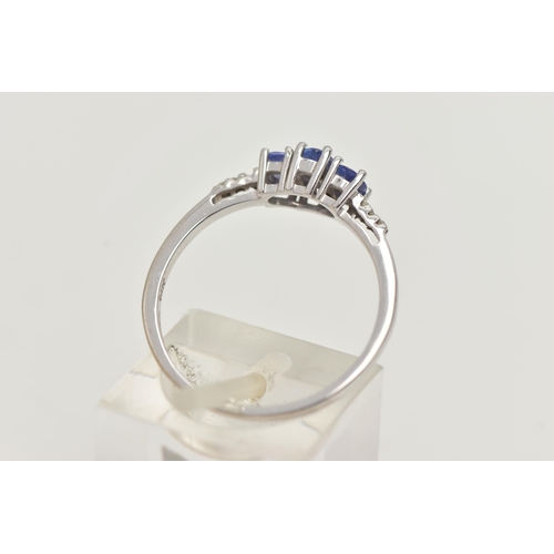 25 - A 14CT WHITE GOLD TANZANITE AND DIAMOND RING, three oval cut tanzanite, each four claw set, small si... 