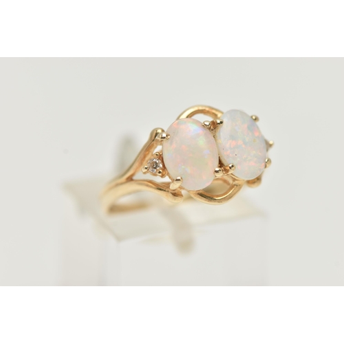 41 - A MODERN YELLOW METAL OPAL AND DIAMOND DRESS RING, set with two oval opal cabochons, claw set, with ... 