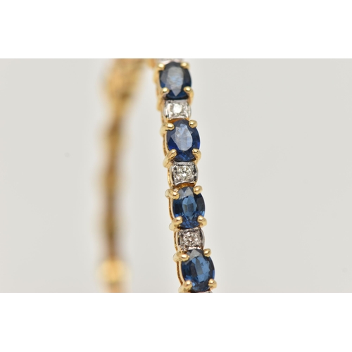 8 - A SAPPHIRE AND DIAMOND BRACELET, designed as a central section of ten oval cut sapphires interspaced... 