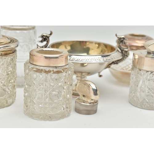 106 - FIVE SILVER TOPPED JARS AND A TWIN HANDLE DISH, to include two glass toilet jars with open silver to... 