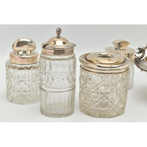 106 - FIVE SILVER TOPPED JARS AND A TWIN HANDLE DISH, to include two glass toilet jars with open silver to... 