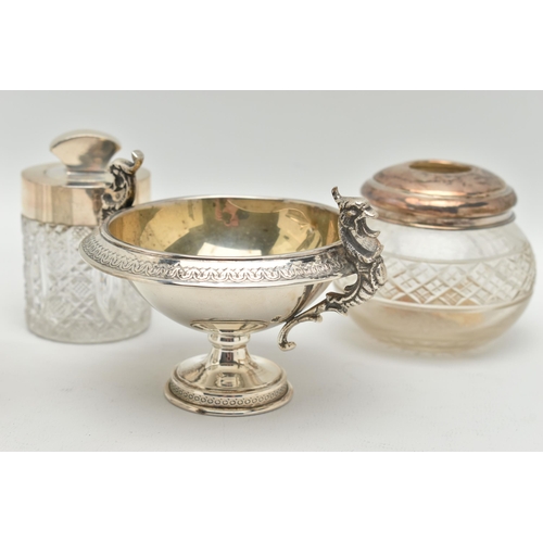 106 - FIVE SILVER TOPPED JARS AND A TWIN HANDLE DISH, to include two glass toilet jars with open silver to... 