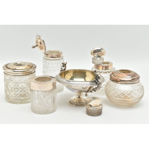 106 - FIVE SILVER TOPPED JARS AND A TWIN HANDLE DISH, to include two glass toilet jars with open silver to... 